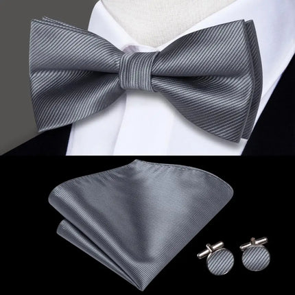 gray bow tie with matching cuff links and pocket square