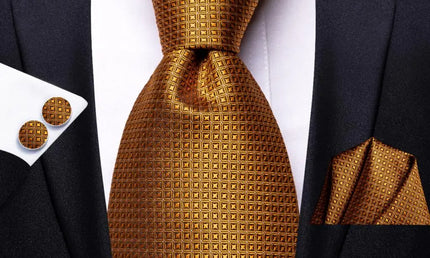 gold geometric pattern tie with matching cuff links and pocket square