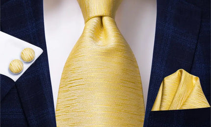 gold textured design tie with cuff links and pocket square
