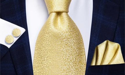 gold textured tie with cuff links and pocket square