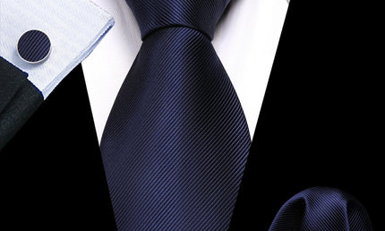 plain dark blue tie with matching cuff links and pocket square